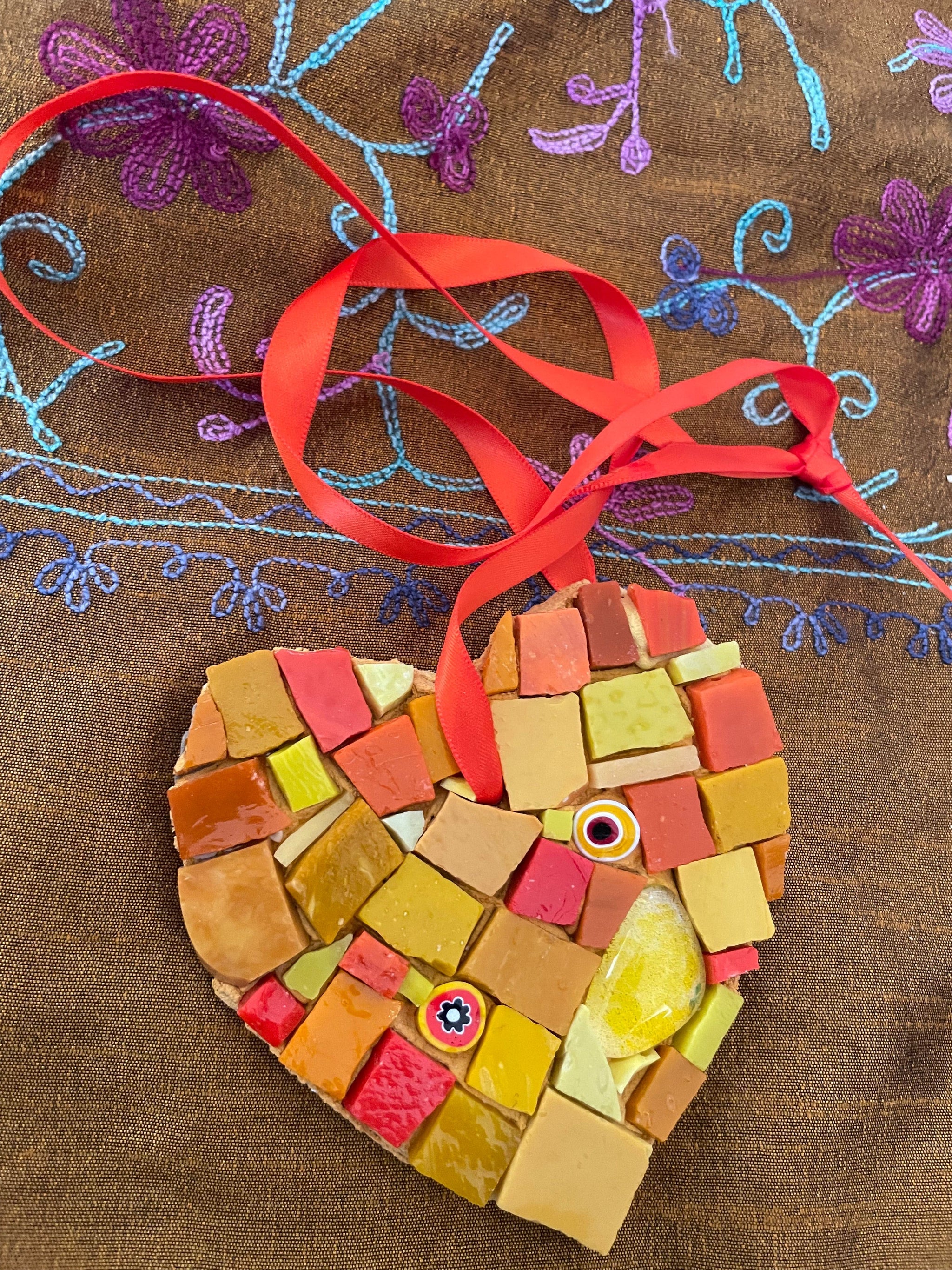 Mosaic artwork- This heart is glass artwork in orange colours.